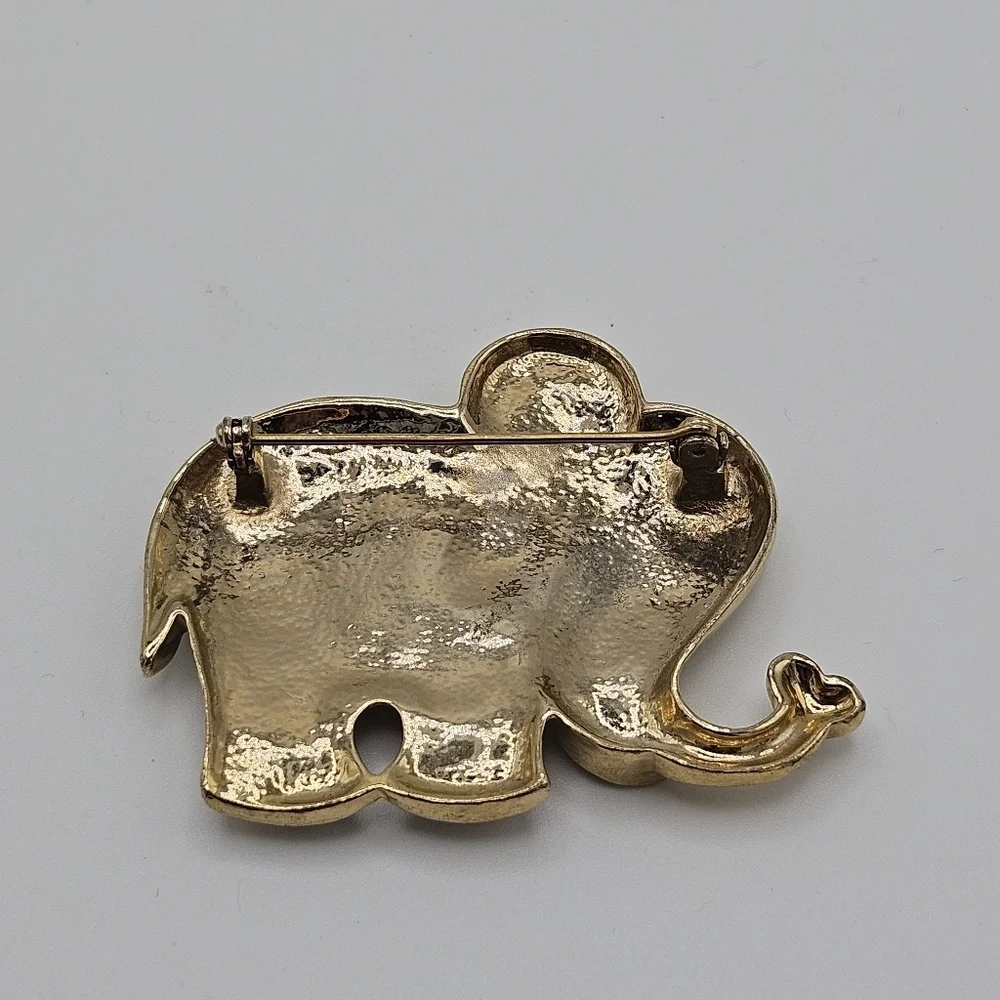 gold tone elephant pin with rhinestones and blue and green enamel